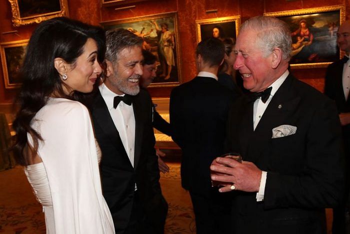 Amal Clooney and George Clooney speak to Prince Charles