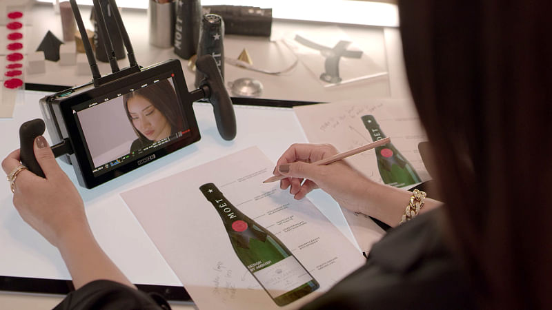 Yoon putting the finishing touches on her design for Moët & Chandon's iconic  Moët Impérial bottle