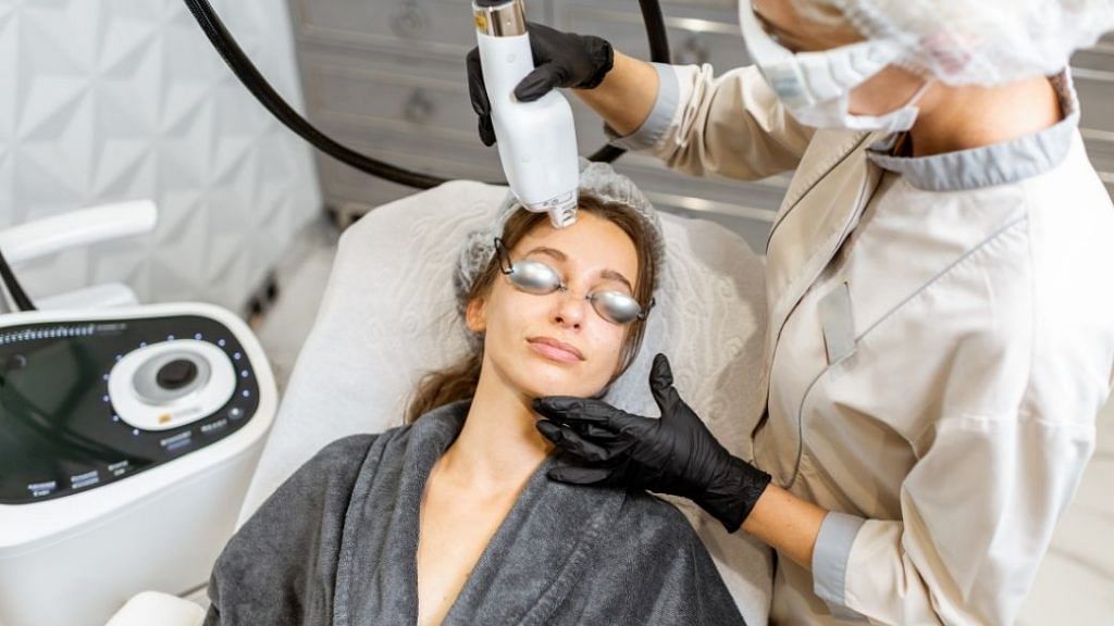 Woman receiving in-clinic laser treatment for dark spots
