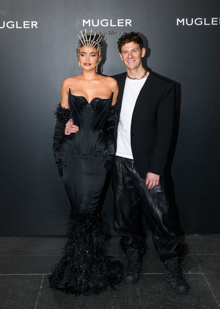 Kylie Jenner with Mugler creative director Casey Cadwallader at the opening party for the Thierry Mugler Couturissime exhibit at the Brooklyn Museum. Jenner wears a dress from Mugler’s fall 1995 couture collection, accessorized with a headpiece from the 1999 couture show, and feather-adorned gloves.
