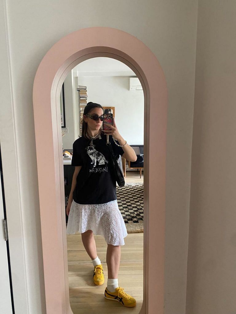 Tara wearing the sneakers with a Vaquera t-shirt, Gimaguas skirt, Chopova Lowena necklace with secondhand Miu Miu sunglasses and Yves Saint Laurent bag from The Real Real.