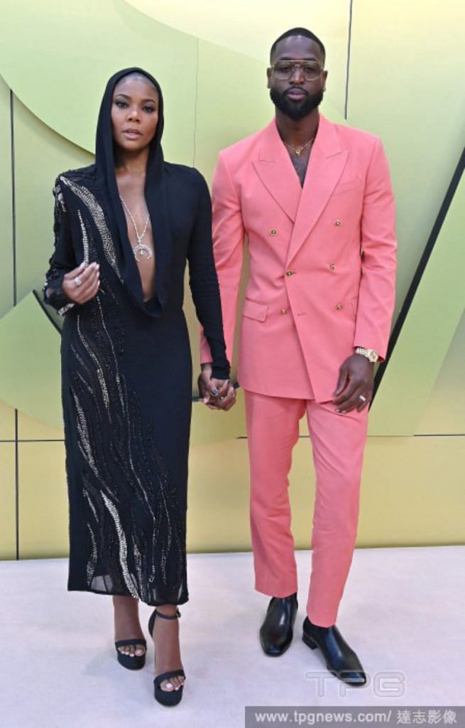 Dwayne Wade looking sharp and sweet in a baby pink shirtless suit