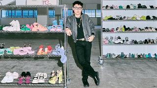 Joe Kean, a BAZAAR NewGen 2022 finalist on a six-month internship with CHARLES & KEITH. Here, he is pictured among the brand’s footwear. Photo: Lawrence Teo